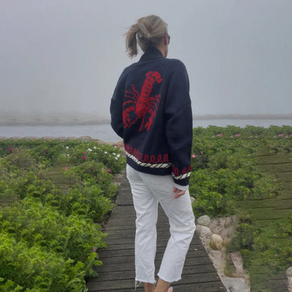 Oversized gebreid damesvest met walvismotief en nautische contrastbies